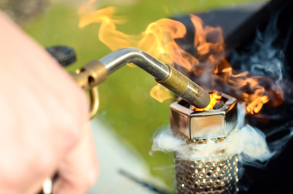 how to smoke cheese on a pellet grill using hard cheese - lighting the smoke tube with a butane torch